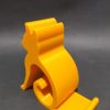Żółta podstawka pod telefon w kształcie sylwetki siedzącego kota, wydruk 3D z PETG Żółta podstawka pod telefon w kształcie sylwetki siedzącego kota, wydruk 3D z PETG